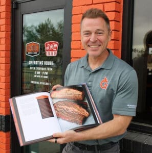 Jason Ganahl shows off his latest project, the first G-Que BBQ cookbook